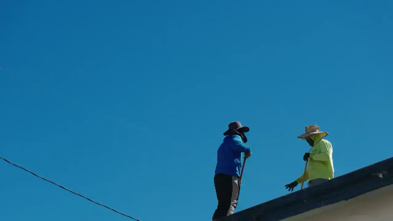 Roofing contractors repairing a home, illustrating recoverable depreciation in a homeowners insurance claim
