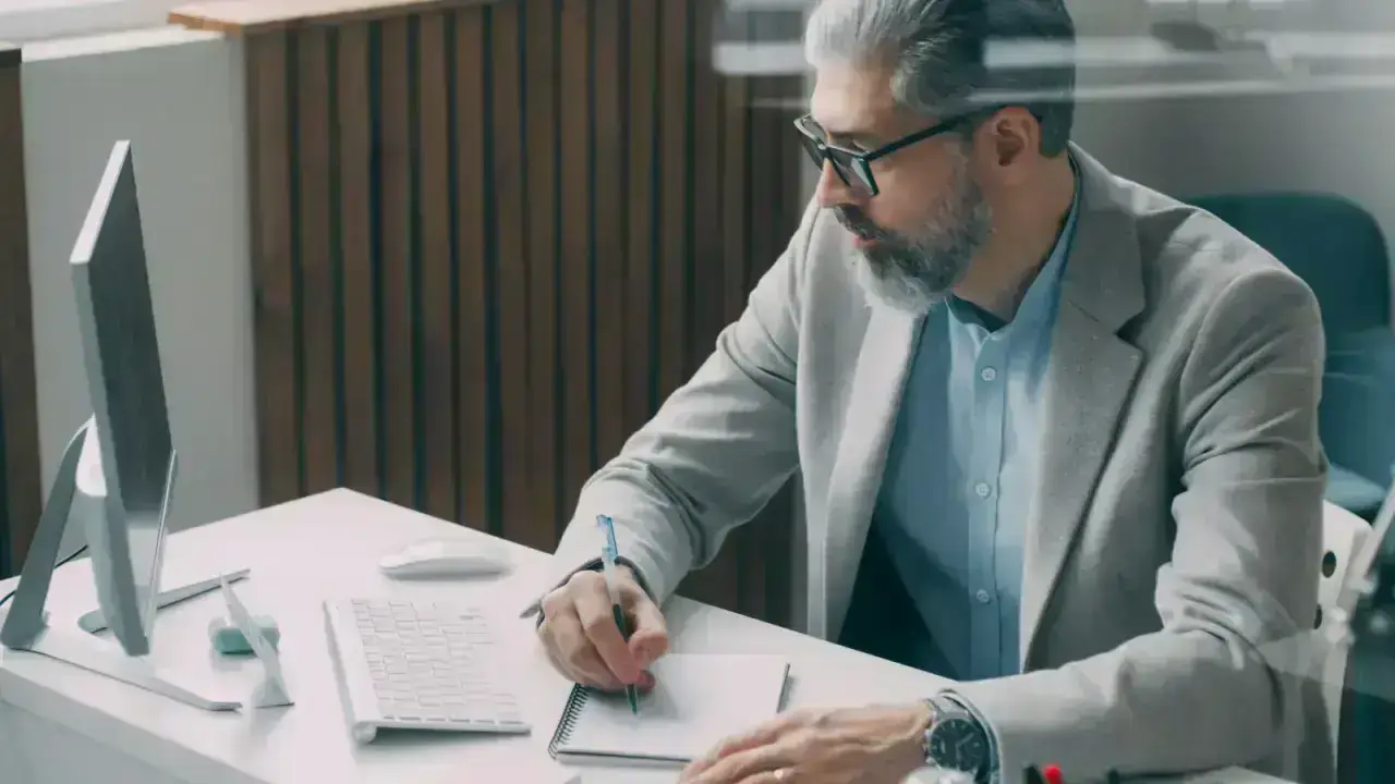 Insurance and finance professional reviewing documents, illustrating reinsurance commission economics