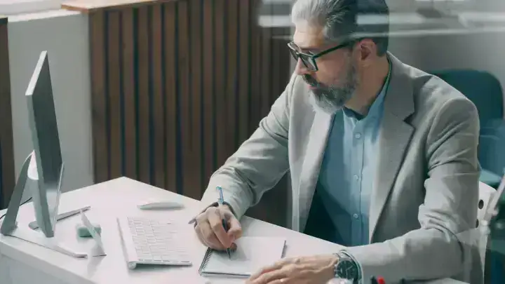 Insurance and finance professional reviewing documents, illustrating reinsurance commission economics