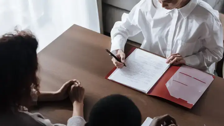 Business professionals reviewing documents illustrating reinsurance intermediary brokerage and management