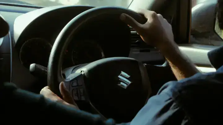 Driver at the wheel illustrating minimum auto liability insurance requirements for vehicle owners