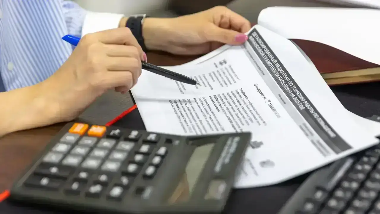 Financial documents and calculator illustrating statutory accounting and GAAP analysis for insurance companies