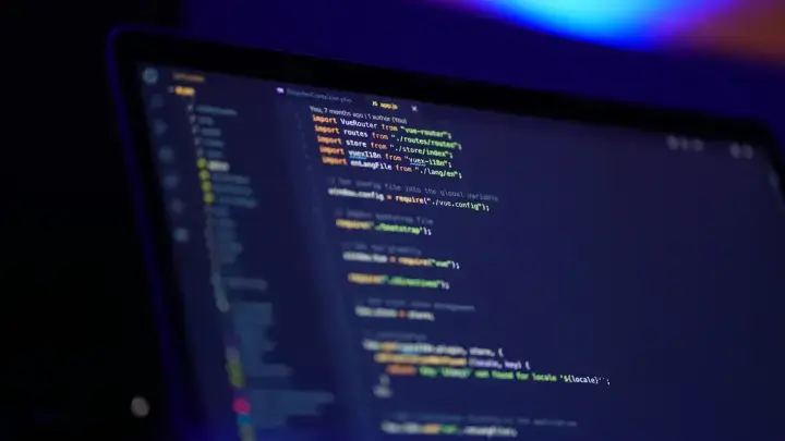 Laptop displaying software code, illustrating technology errors and omissions and cyber insurance risks for technology companies