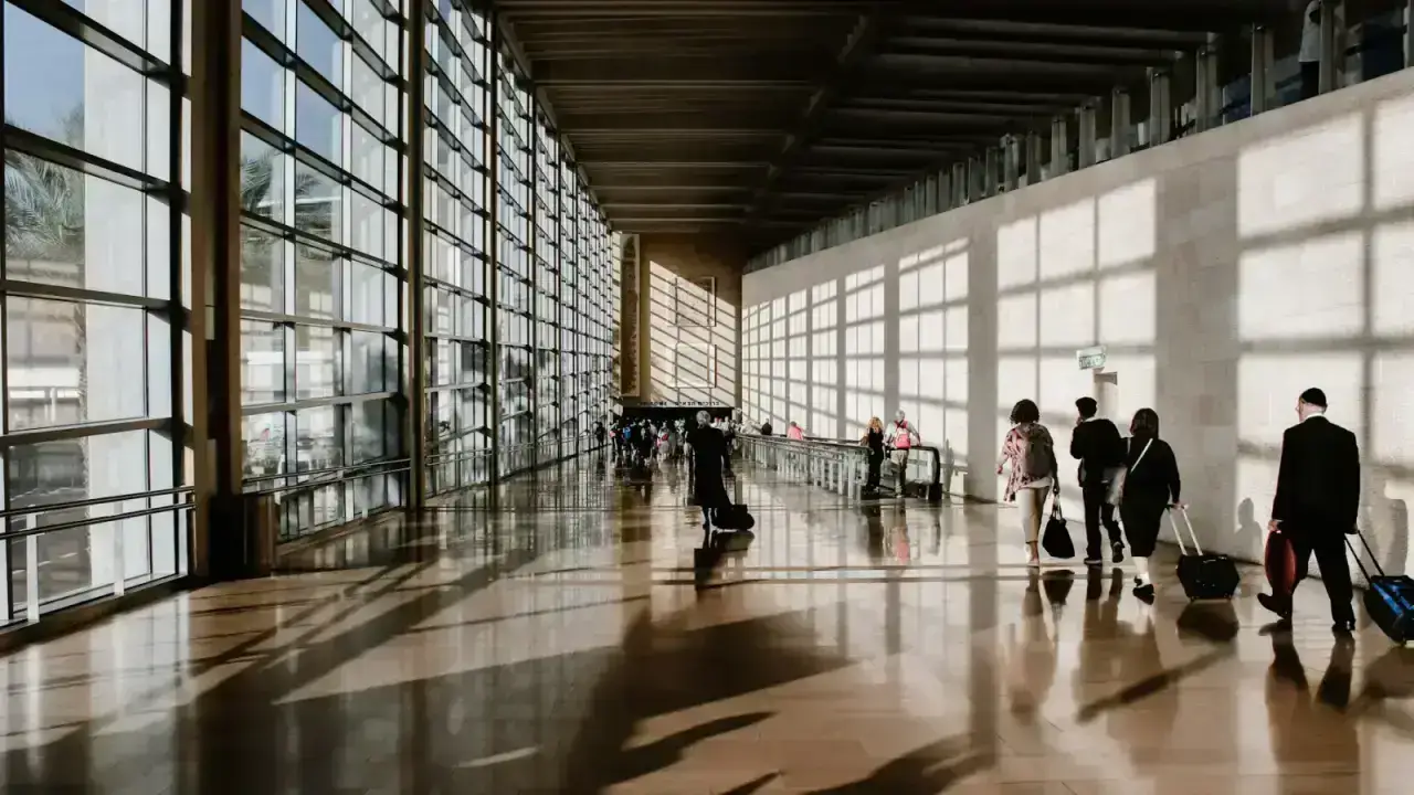 Travelers at an airport illustrating trip insurance for terrorism civil unrest and travel advisories