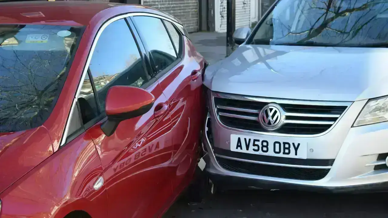 Two vehicles after a road collision illustrating an auto insurance claim checklist for drivers